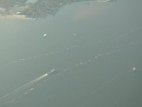 Ferry, sailboat, and lighthouse in the Block Island Sound.