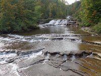 The layered geological structure that makes the falls so interesting.