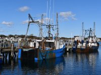 Fishing boats moored to the pier.